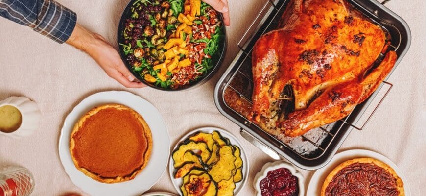 Man,Putting,Fresh,Salad,On,The,Table,Full,Of,Traditional